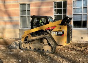 CAT Skid Steer moving dirt on a construction site