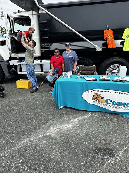 Comer Construction truck and table at touch a truck event