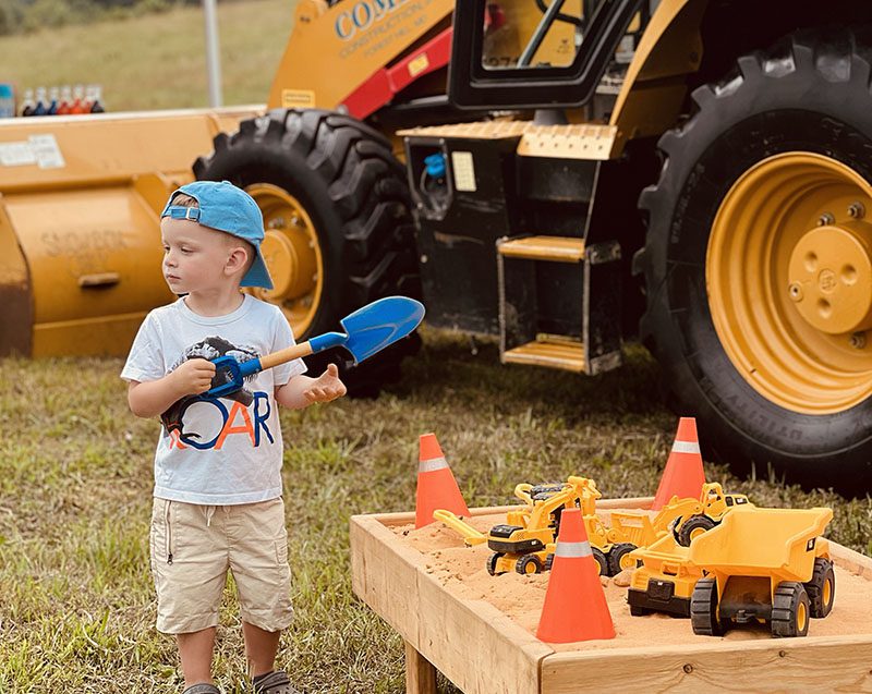 young boy playing at touch a truck