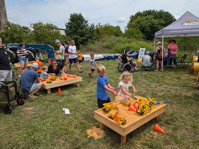 crowd playing in sandboxes at touch a truck