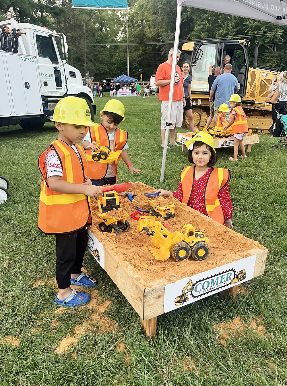 kids playing in Comer Construction sandboxes at 2024 National Night Out