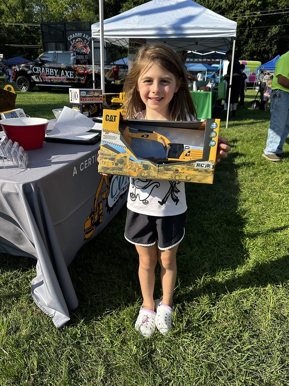 Young girl with Comer Construction prize at 2024 National Night Out